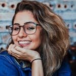Closeup Photo of Smiling Woman Wearing Blue Denim Jacket