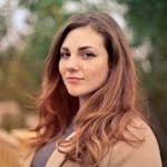Closeup Photo of Woman With Brown Coat and Gray Top